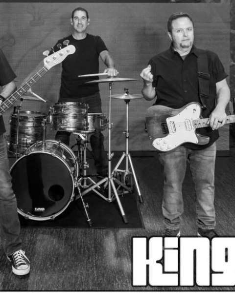 Three band members pose with their instruments in a black-and-white photo. The logo 