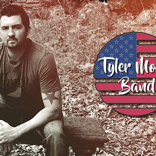 A man sits on a bench outdoors. To the right, there's a logo resembling an American flag with the text "Tyler Moore Band."